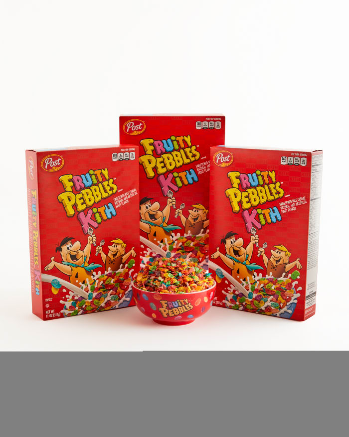 Fruity Pebbles cereal boxes next to a cereal bowl.